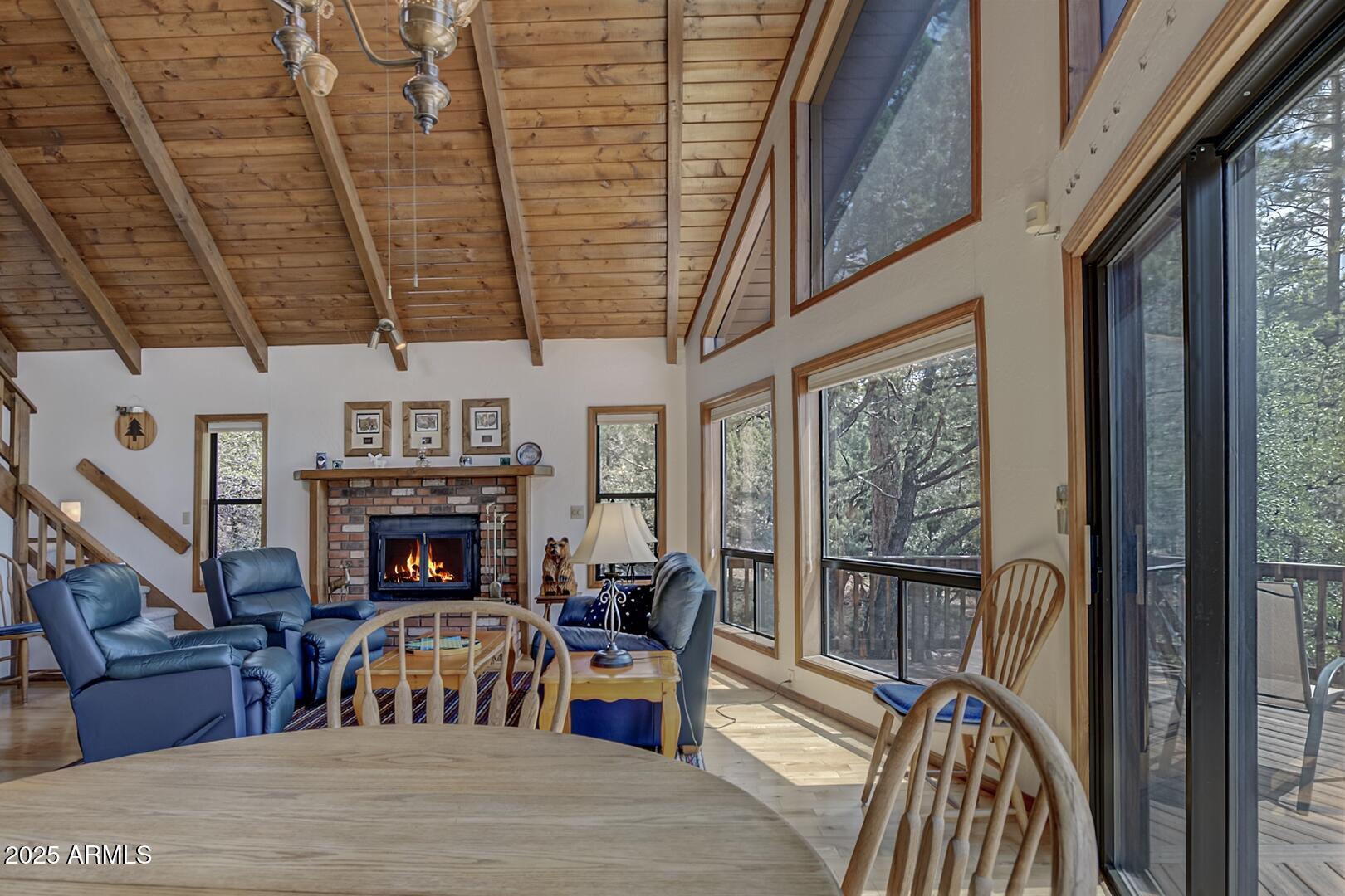 5838 Arroyo Way Pine, AZ 85544 - Photo 3 of 53 a view of a livingroom with furniture a fireplace and windows
