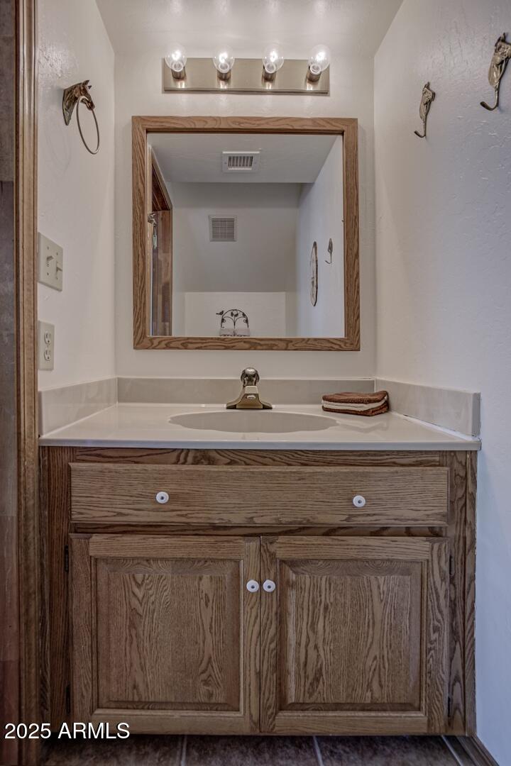 5838 Arroyo Way Pine, AZ 85544 - Photo 31 of 53 a bathroom with a sink and a mirror