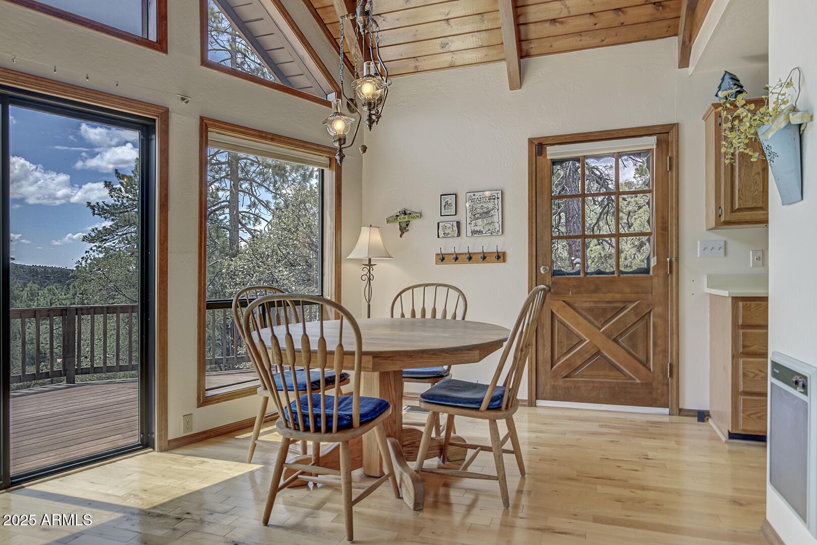 5838 Arroyo Way Pine, AZ 85544 - Photo 4 of 53 a view of a dining room with furniture wooden floor and a chandelier
