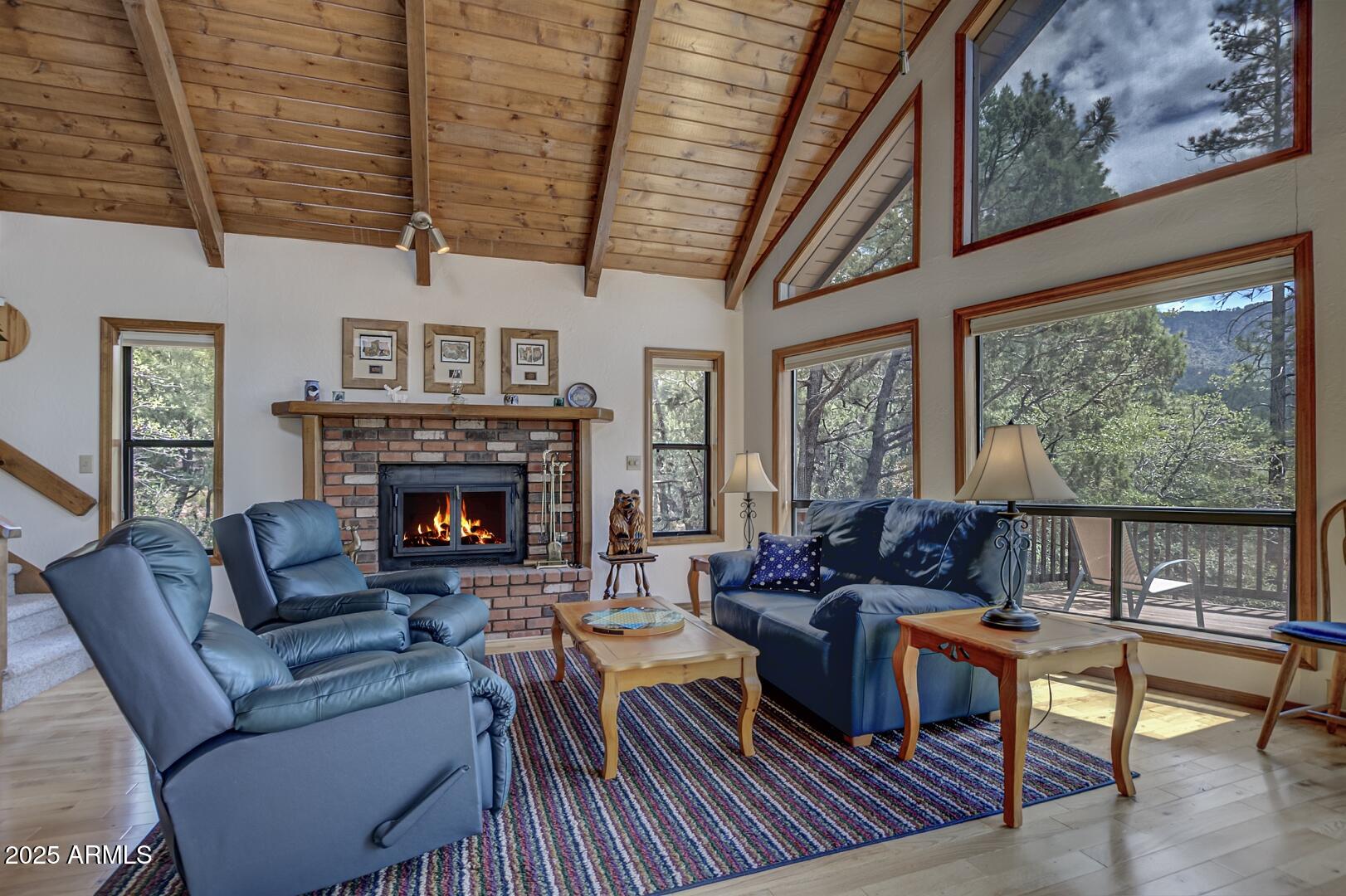 5838 Arroyo Way Pine, AZ 85544 - Photo 5 of 53 a living room with furniture a fireplace and a table