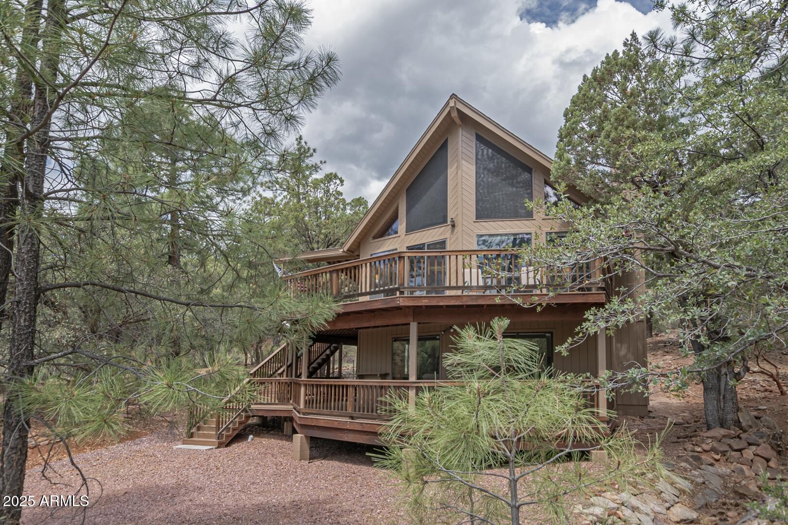 5838 Arroyo Way Pine, AZ 85544 - Photo 51 of 53 a backyard of a house with wooden deck and seating space