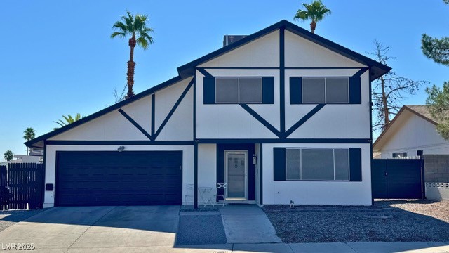View of front of home with driveway, an attached garage, and stucco siding