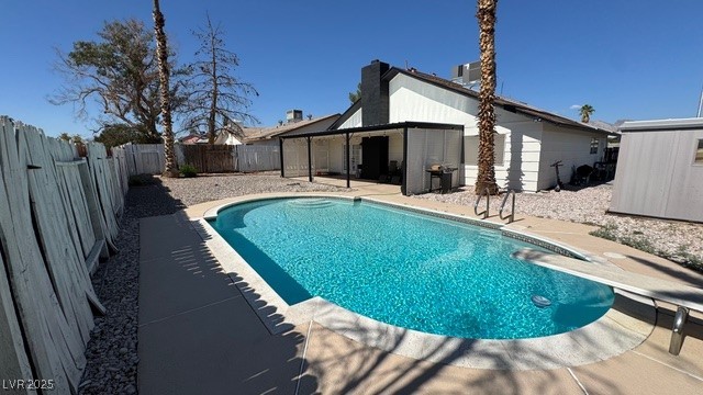 809 Peacock Court Las Vegas, NV 89145 - Photo 12 of 15 View of pool featuring a patio, a diving board, and a fenced backyard