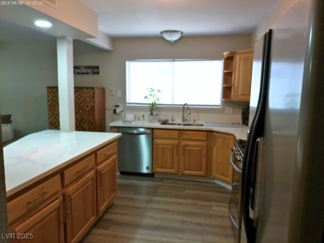 809 Peacock Court Las Vegas, NV 89145 - Photo 7 of 15 Kitchen featuring stainless steel appliances, light countertops, open shelves, luxury vinyl plank floors, and brown cabinets