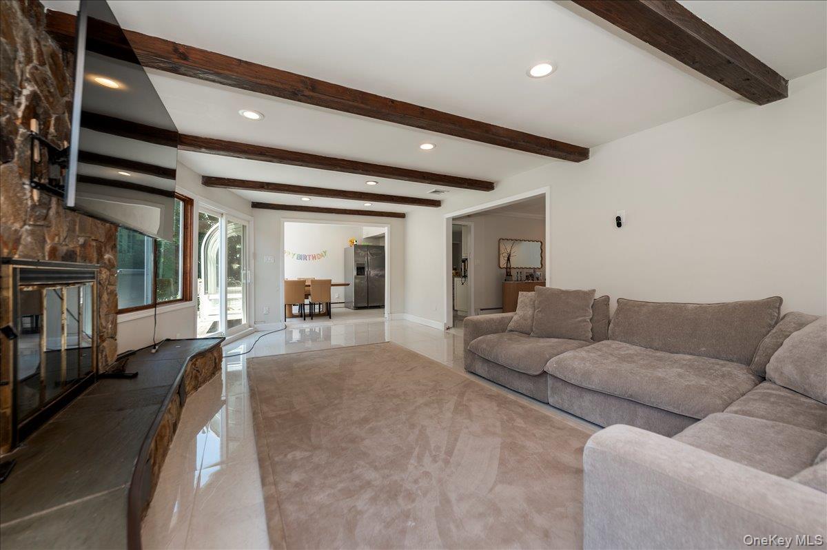 70 Longfellow Road Great Neck, NY 11023 - Photo 16 of 28 a living room with furniture and a gym machine