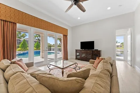 a living room with furniture rug and a ceiling fan