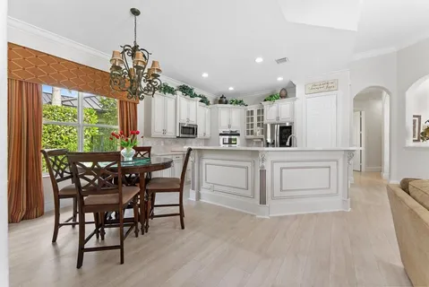 a kitchen with a sink stainless steel appliances and window
