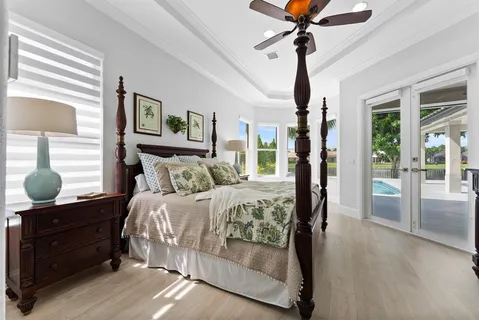 a bathroom with a granite countertop tub a double vanity sink and a large mirror