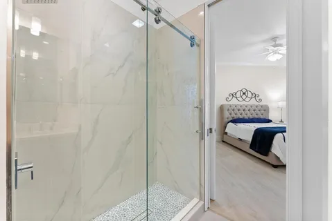 a utility room with stainless steel appliances granite countertop a sink a stove and cabinets