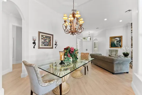 a living room with furniture a flat screen tv and a window