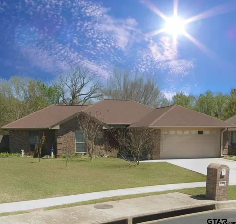 a view of a big house with a big yard and large trees