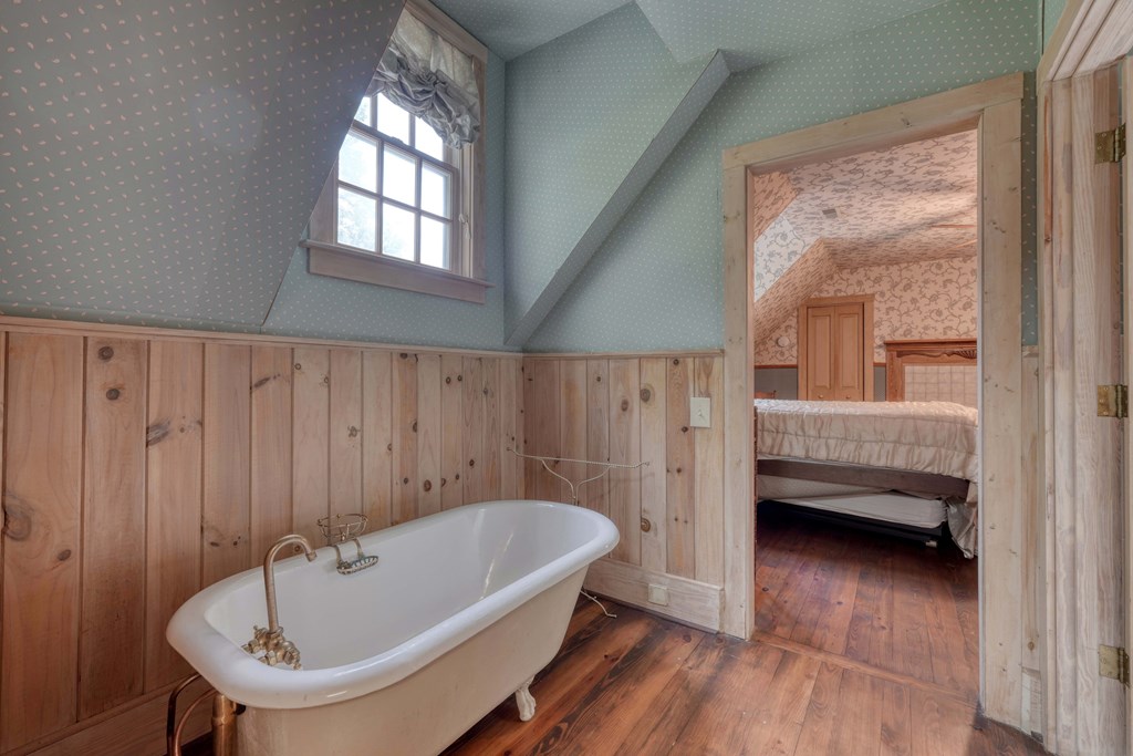 2350 Dial Road Blue Ridge, GA 30513 - Photo 35 of 76 a bathroom with a tub a sink and wooden floor
