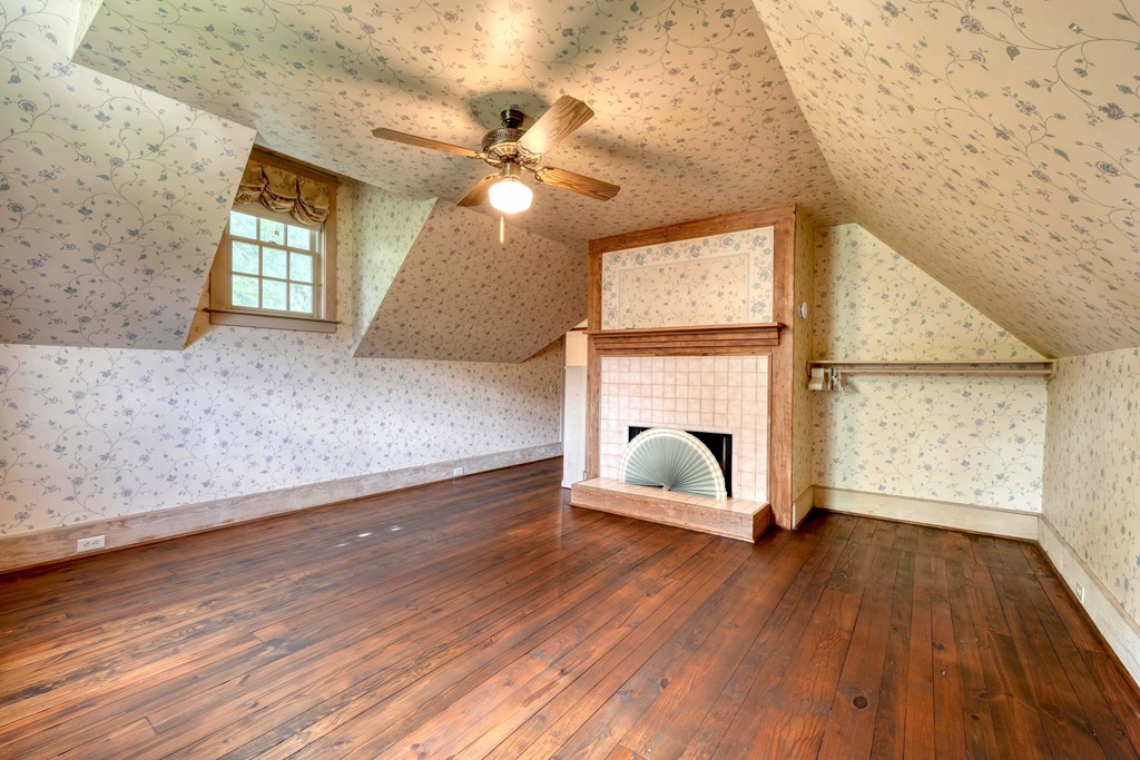 2350 Dial Road Blue Ridge, GA 30513 - Photo 37 of 76 an empty room with wooden floor fan and windows