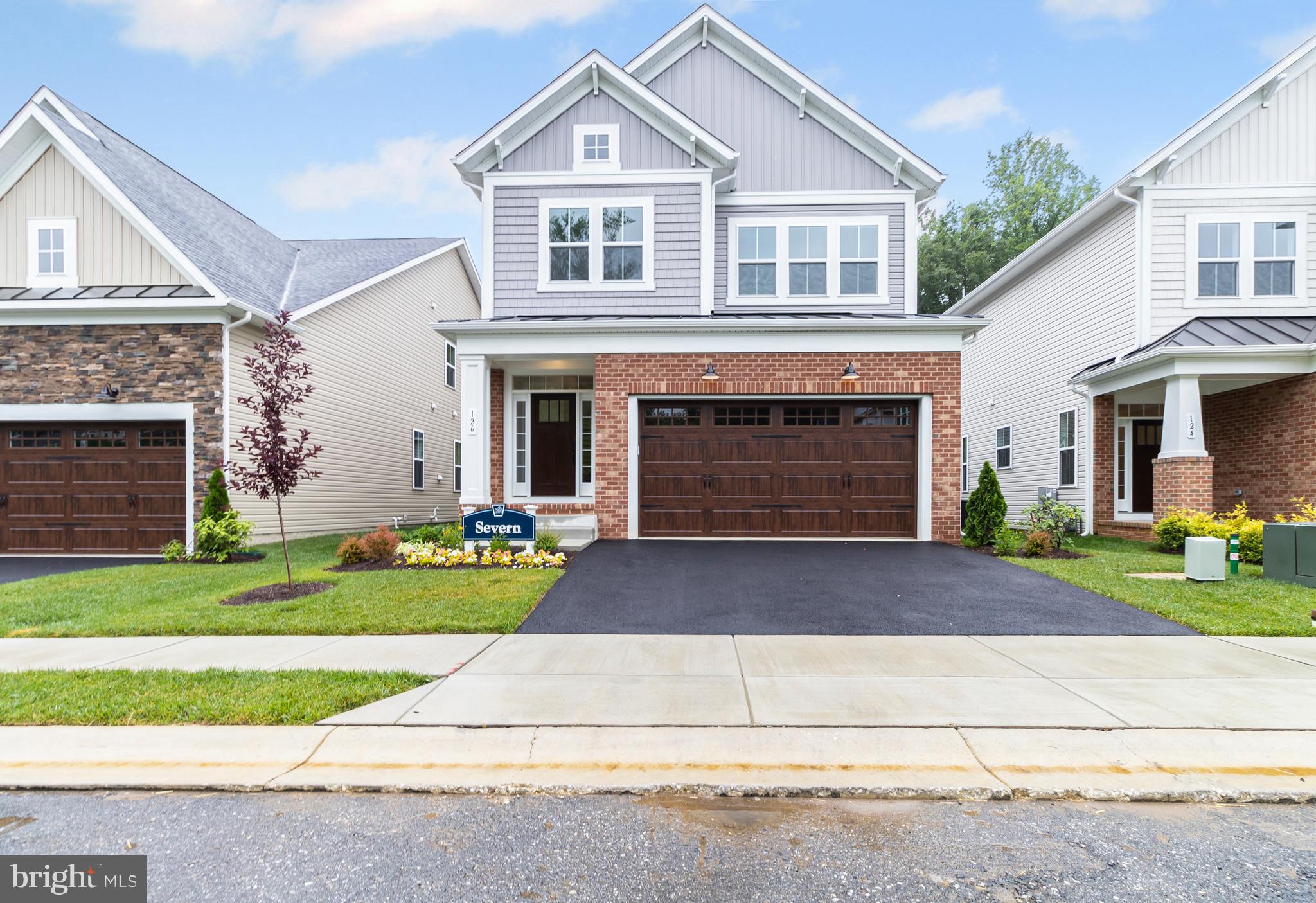 a front view of a house with a garden and yard