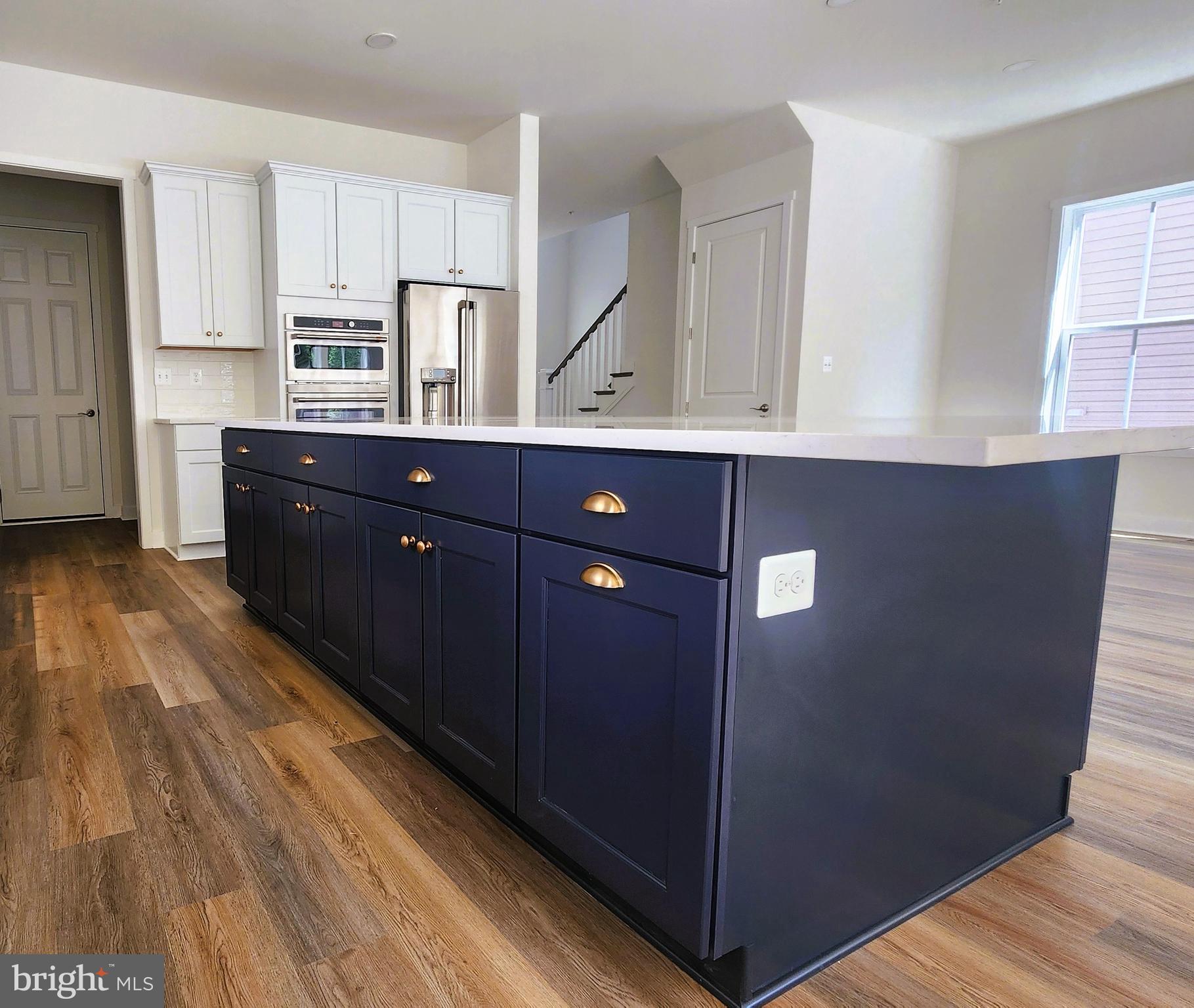 126 Sadie Way Arnold, MD 21012 - Photo 10 of 41 a kitchen with stainless steel appliances granite countertop a refrigerator a sink dishwasher and wooden cabinets with wooden floor