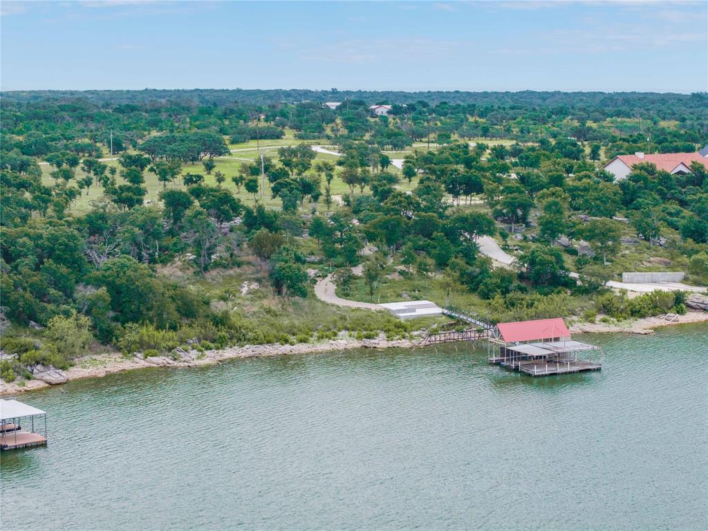 977 Deep Water Road May, TX 76857 - Photo 8 of 36 an aerial view of a house with a garden and lake view