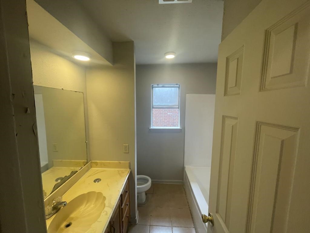 12779 Enchanted Path Drive Houston, TX 77044 - Photo 9 of 11 a bathroom with a tub a sink a mirror and a shower
