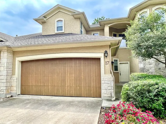 a front view of a house with a garage