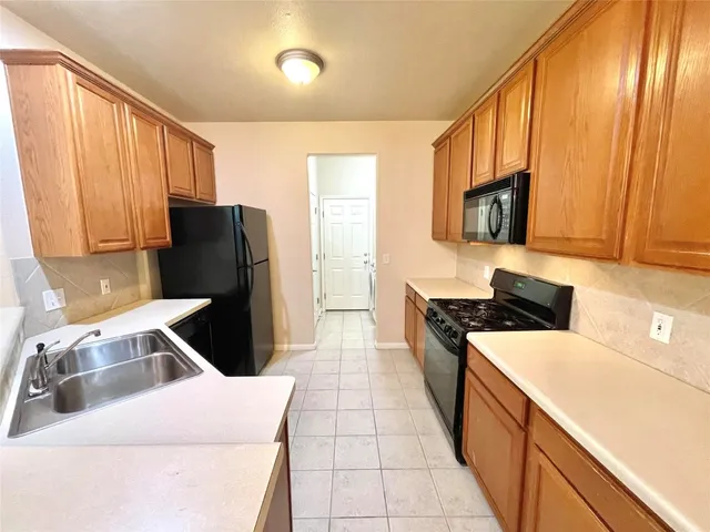 a kitchen with a refrigerator and a sink
