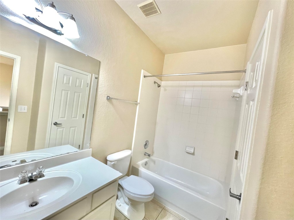 7708 San Felipe Boulevard, Unit 17 Austin, TX 78729 - Photo 7 of 10 a bathroom with a sink a toilet and shower