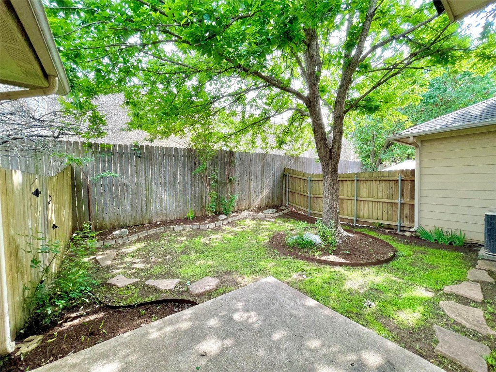 7708 San Felipe Boulevard, Unit 17 Austin, TX 78729 - Photo 9 of 10 a view of a backyard with plants and a lake view