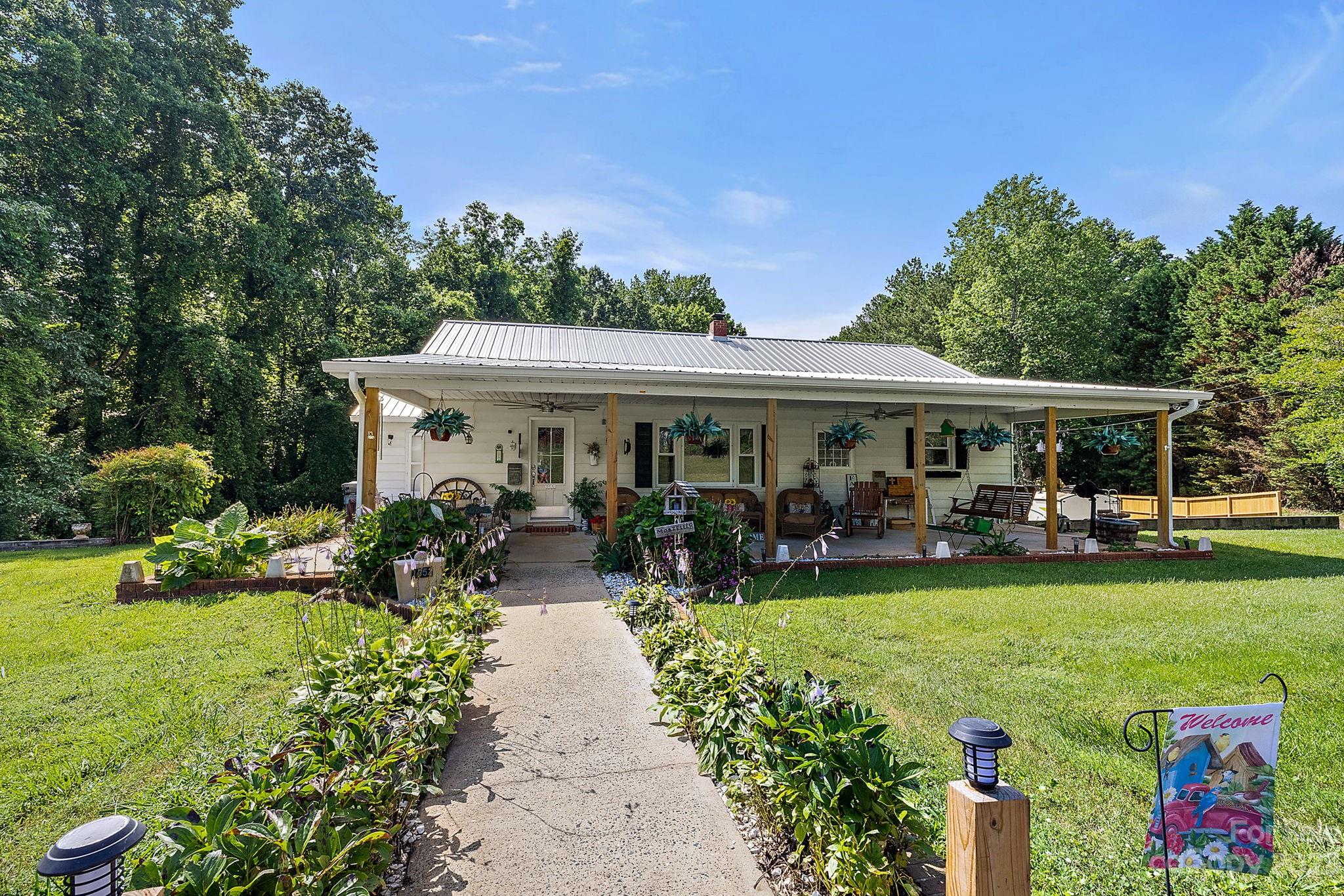 1353 Miles Road Dallas, NC 28034 - Photo 1 of 41 a view of a house with swimming pool and garden