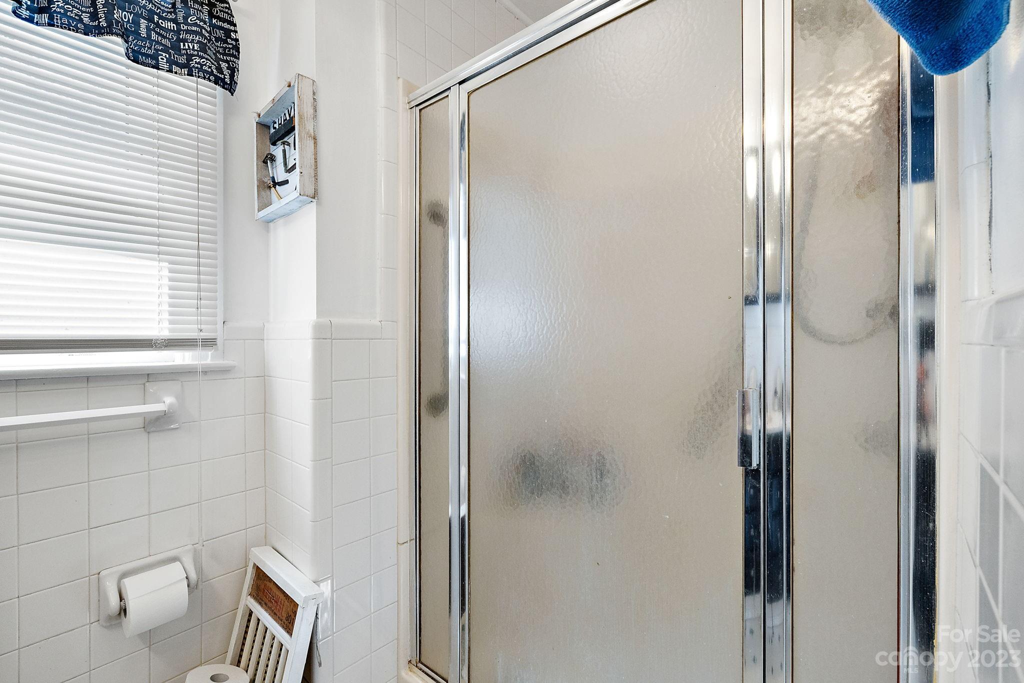 1353 Miles Road Dallas, NC 28034 - Photo 20 of 41 a bathroom with a glass shower door and a sink