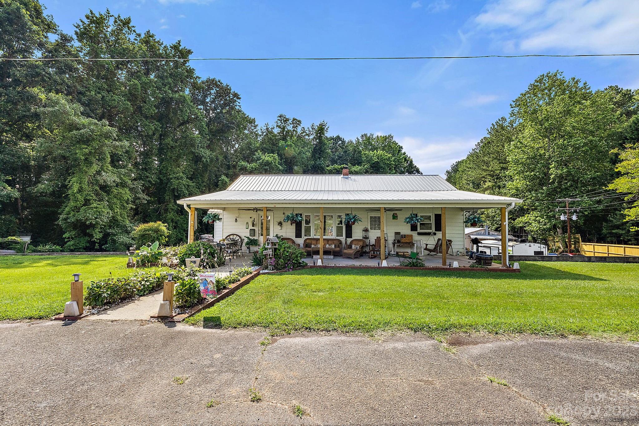 1353 Miles Road Dallas, NC 28034 - Photo 2 of 41 a view of a house with garden and a trees