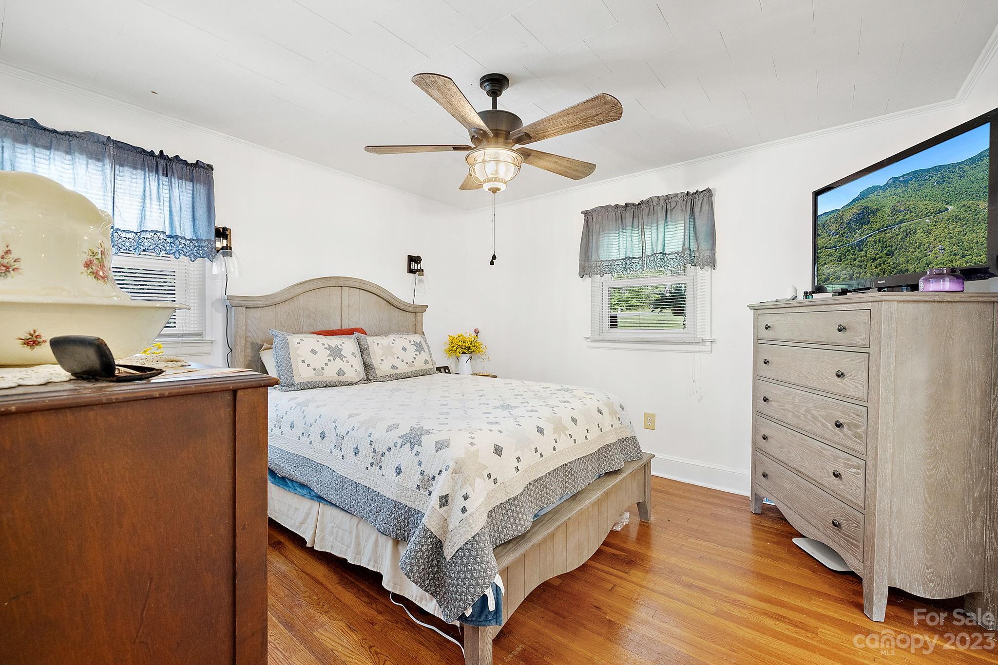 1353 Miles Road Dallas, NC 28034 - Photo 24 of 41 a bedroom with a bed and a dresser with the wooden floor