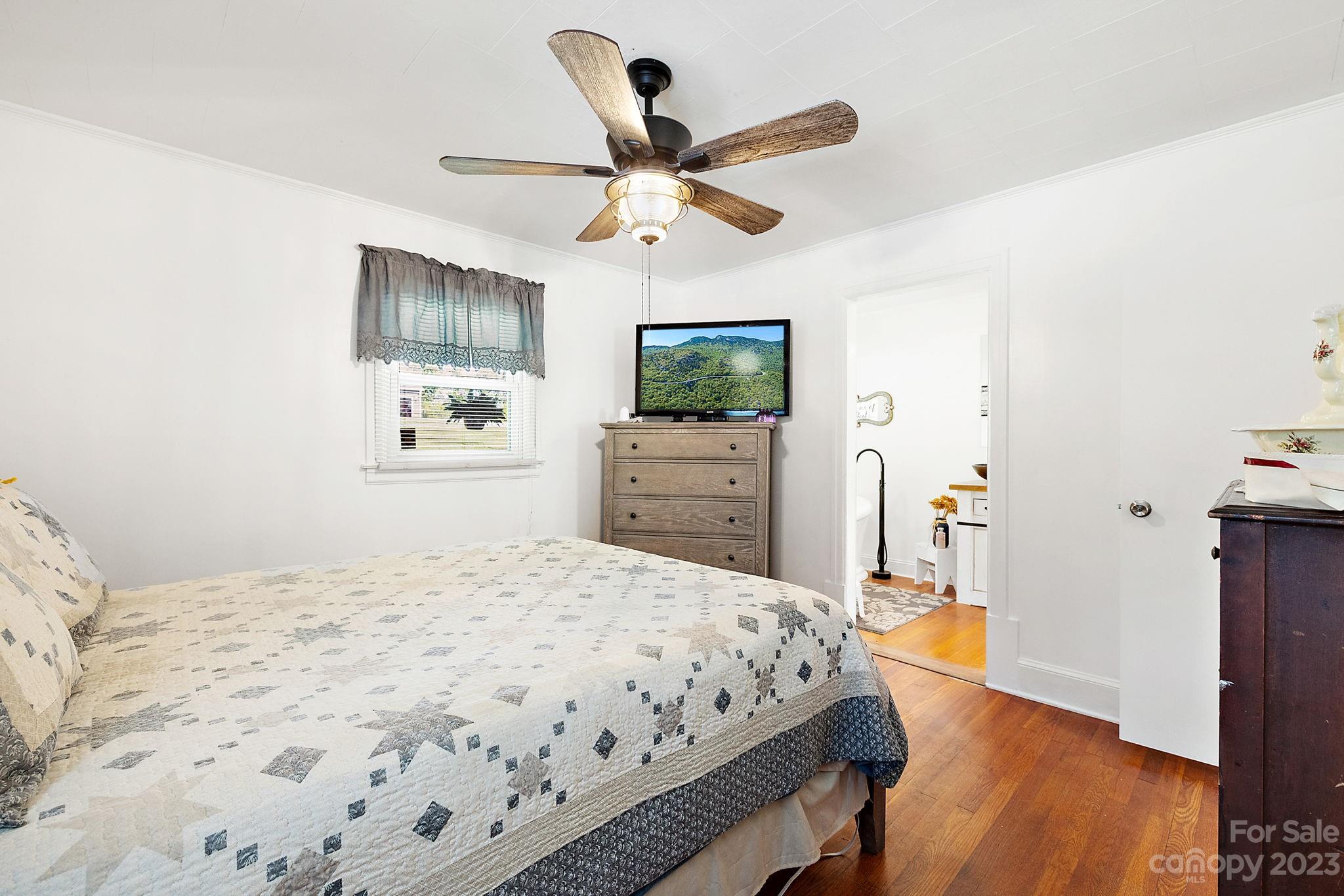 1353 Miles Road Dallas, NC 28034 - Photo 26 of 41 a bedroom with a bed and a flat screen tv