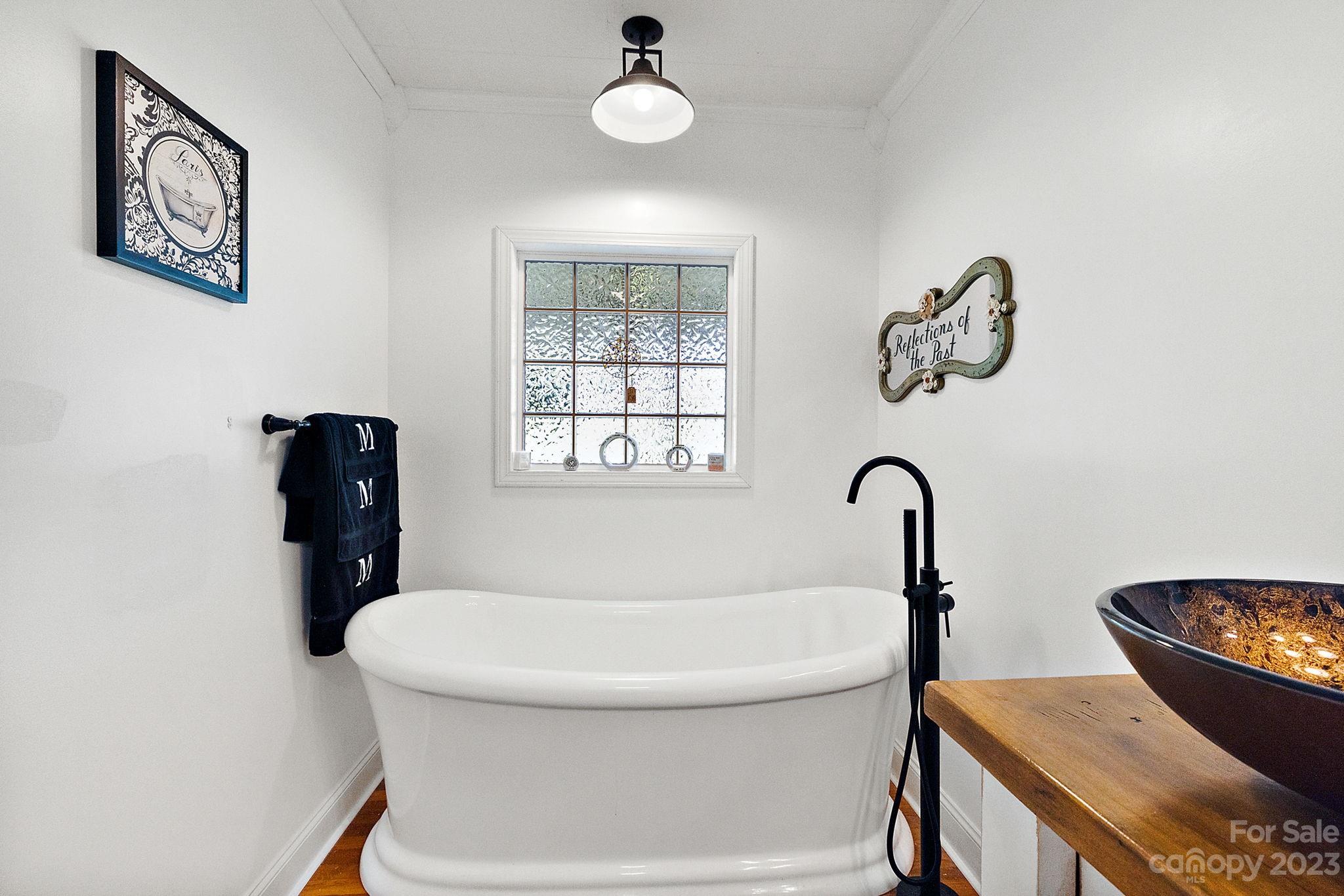 1353 Miles Road Dallas, NC 28034 - Photo 29 of 41 a bathroom with a bathtub and a window