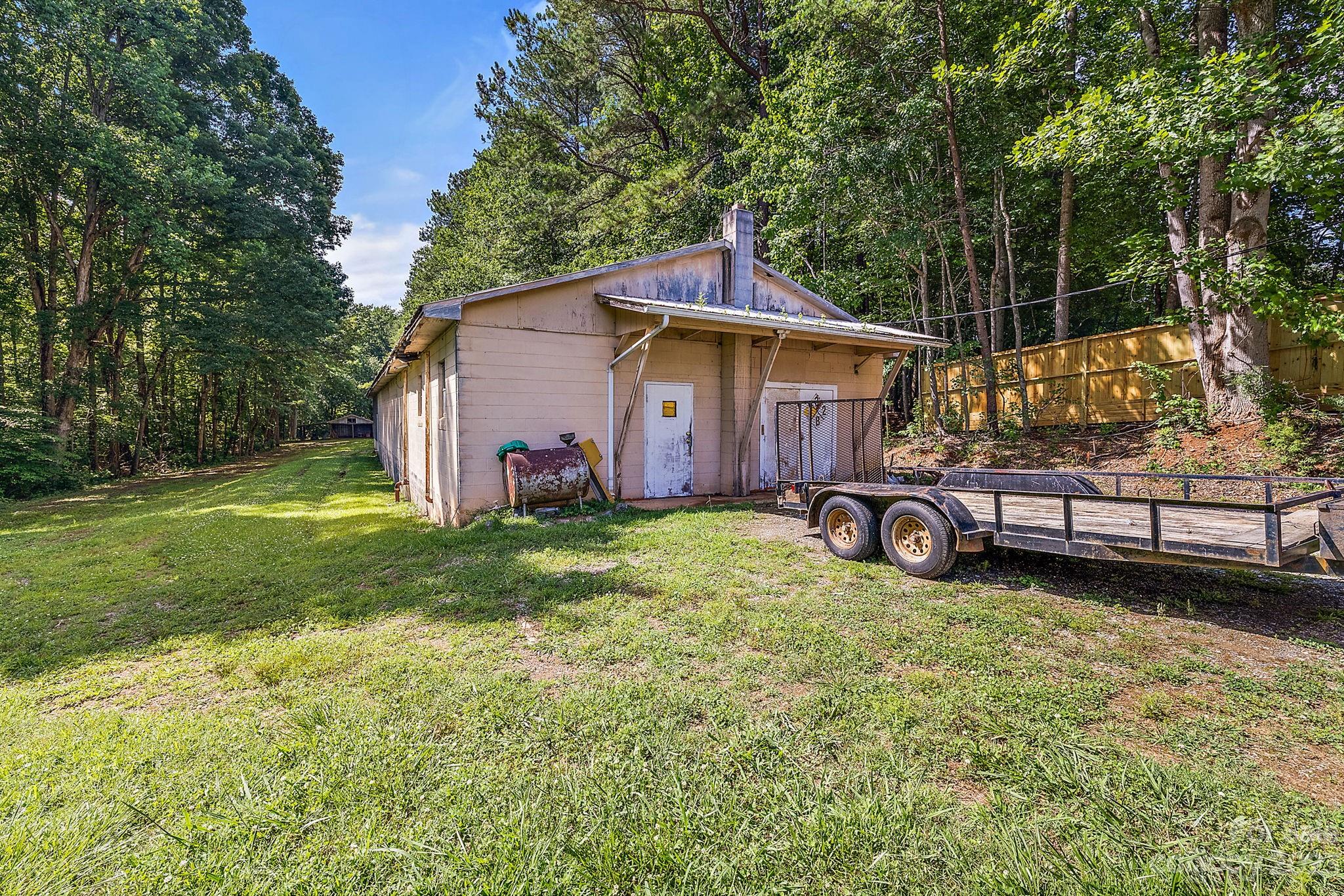 1353 Miles Road Dallas, NC 28034 - Photo 32 of 41 a view of a house with backyard and roof