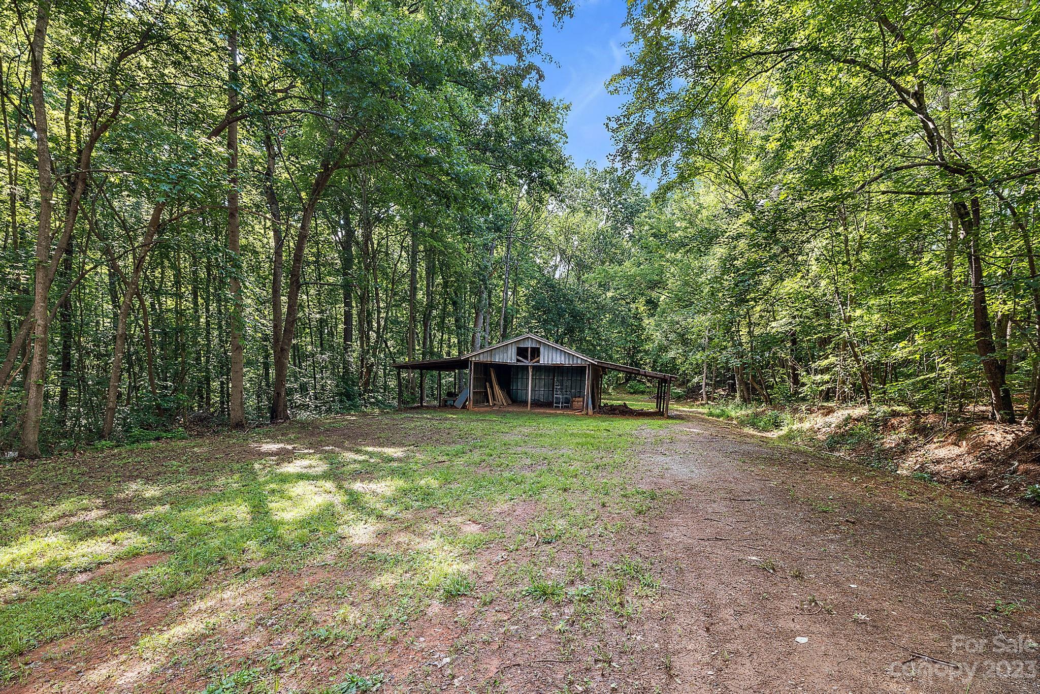 1353 Miles Road Dallas, NC 28034 - Photo 35 of 41 a backyard of a house with trees and entertaining space