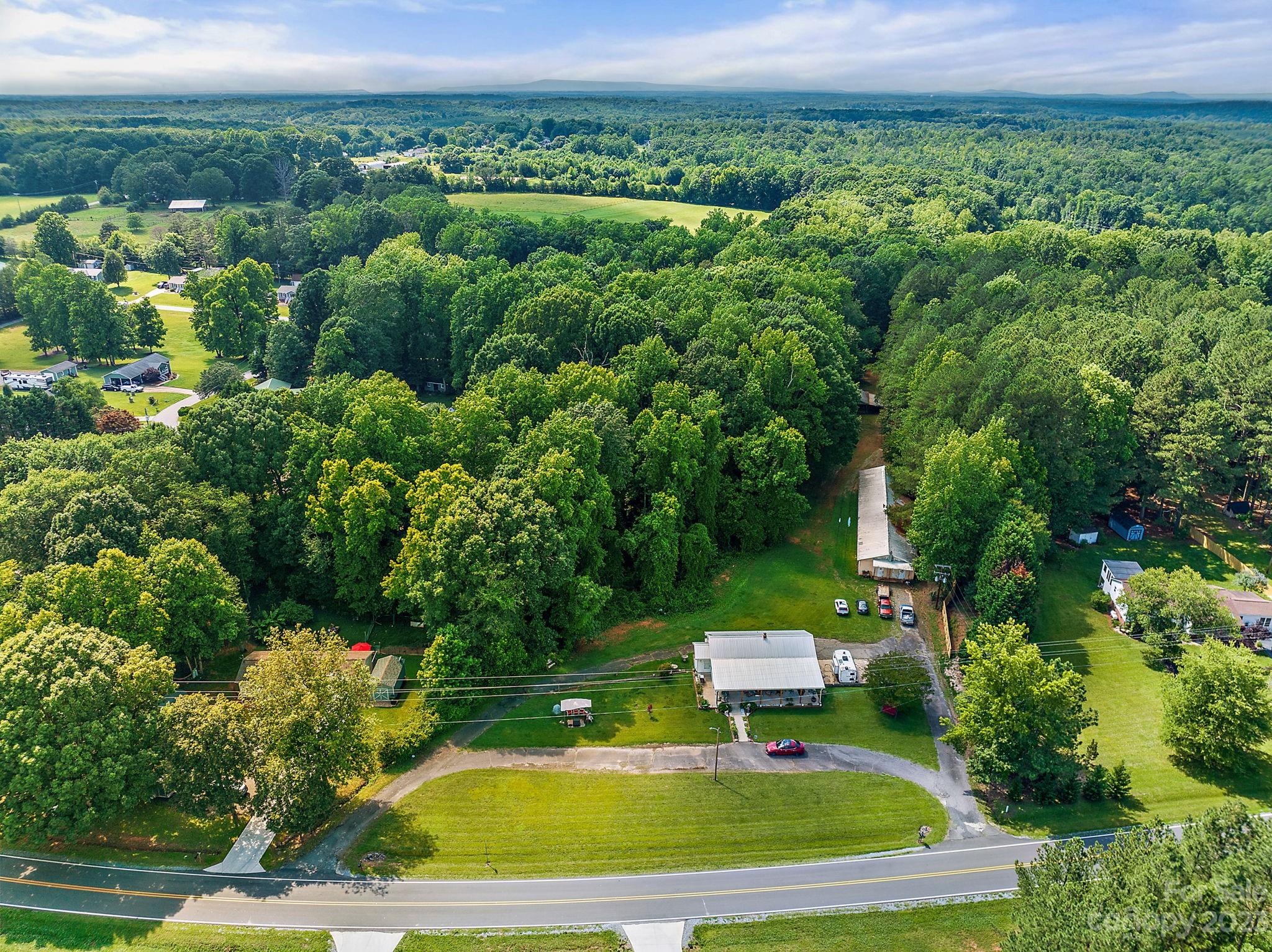 1353 Miles Road Dallas, NC 28034 - Photo 39 of 41 a view of a big yard with potted plants and large trees