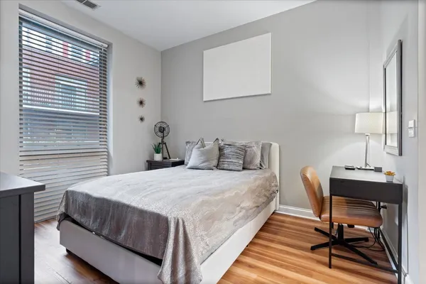 a bedroom with a bed a desk and chair