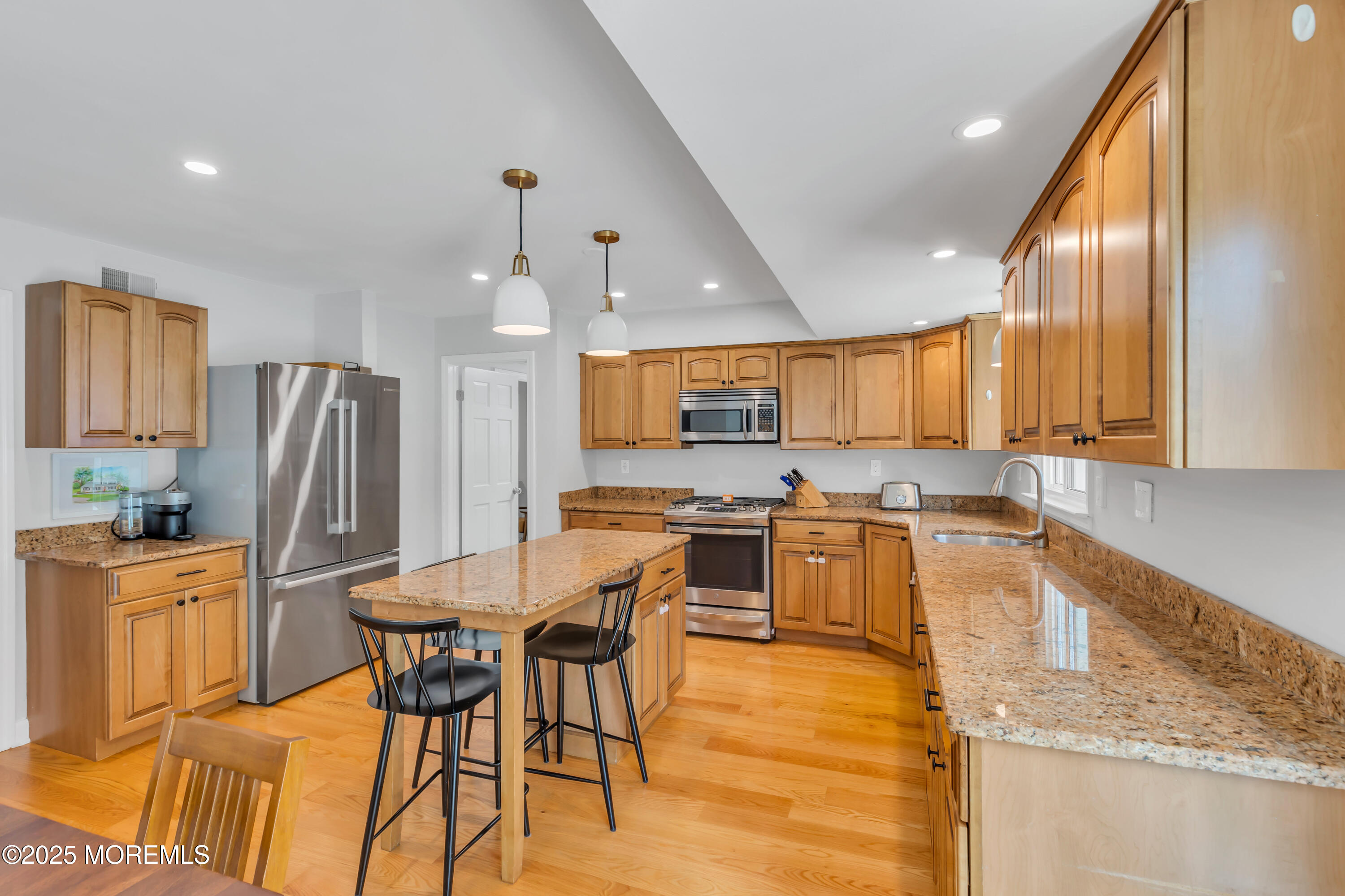 8 Allston Street Red Bank, NJ 07701 - Photo 19 of 64 a kitchen with stainless steel appliances kitchen island granite countertop a refrigerator a stove a sink dishwasher with a dining table and chairs