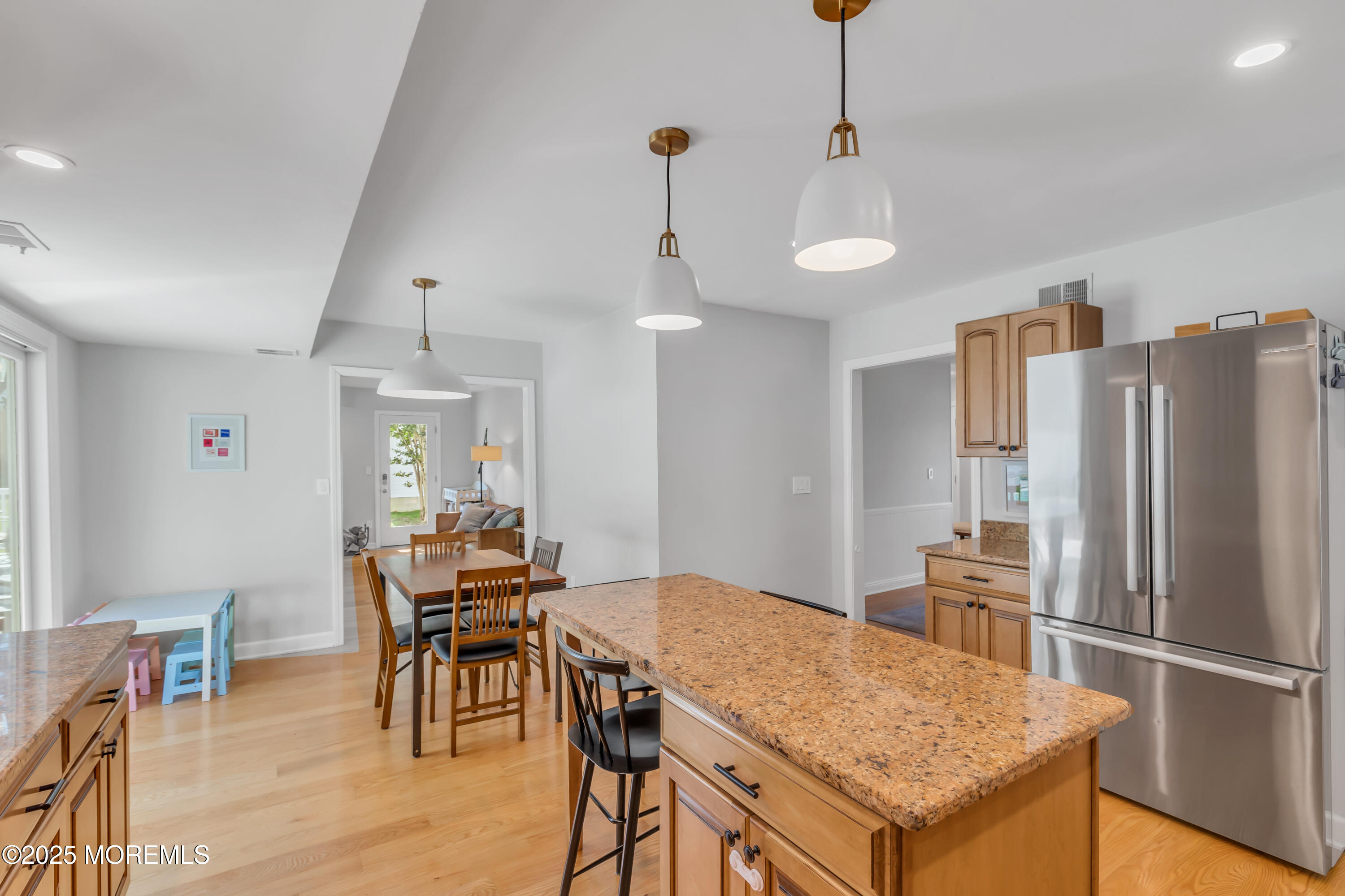 8 Allston Street Red Bank, NJ 07701 - Photo 25 of 64 a kitchen with stainless steel appliances granite countertop a dining table chairs refrigerator and cabinets