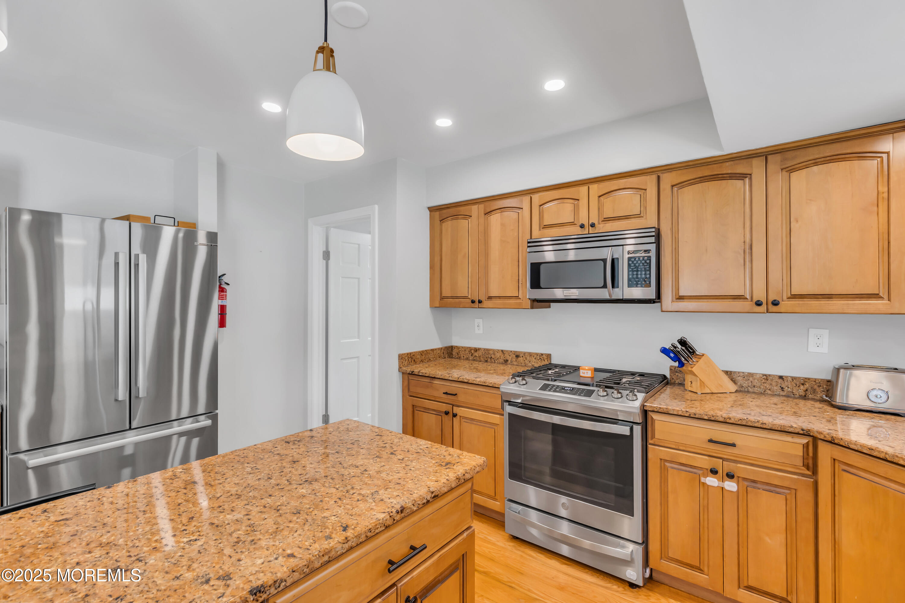 8 Allston Street Red Bank, NJ 07701 - Photo 26 of 64 a kitchen with stainless steel appliances granite countertop a stove a sink and a refrigerator
