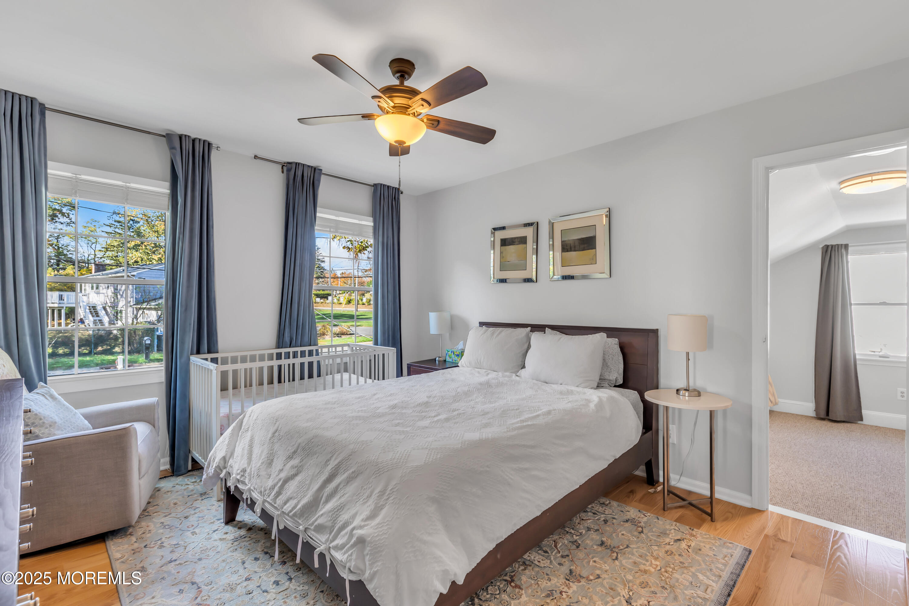 8 Allston Street Red Bank, NJ 07701 - Photo 38 of 64 a bedroom with a bed and a chandelier