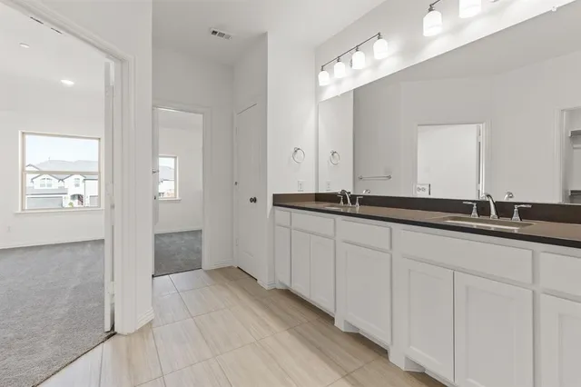 a bathroom with a double vanity sink and mirror
