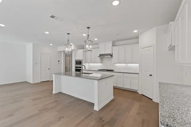 a kitchen with a sink stove and refrigerator
