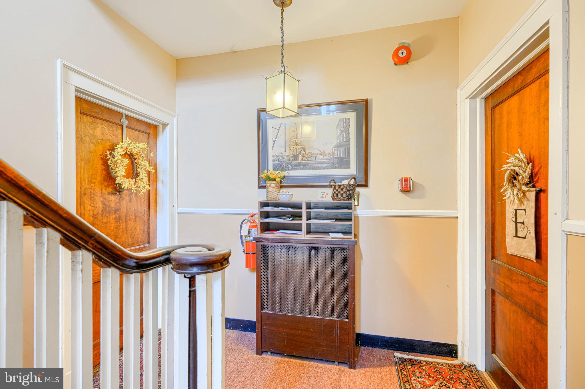 607 Somerset Road, Unit 5 Baltimore, MD 21210 - Photo 37 of 38 a view of a hallway with paintings on the walls