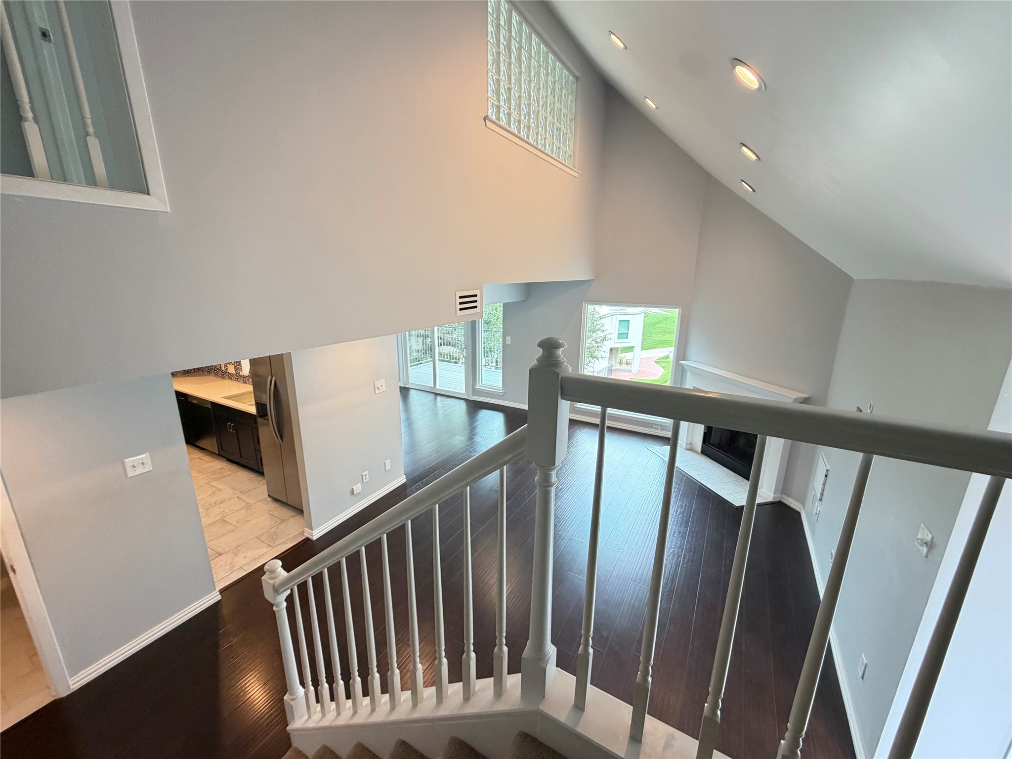 2918 Ranch Road 620 North, Unit C120 Austin, TX 78734 - Photo 24 of 34 Dramatic vaulted ceilings create an open, airy ambiance above polished hardwood flooring and a cozy fireplace.