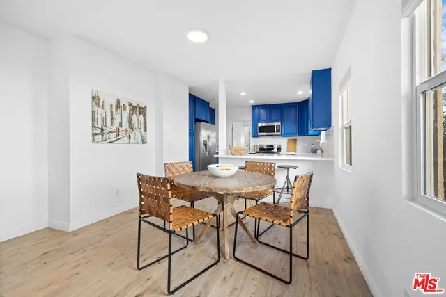a kitchen with stainless steel appliances granite countertop wood cabinets and refrigerator