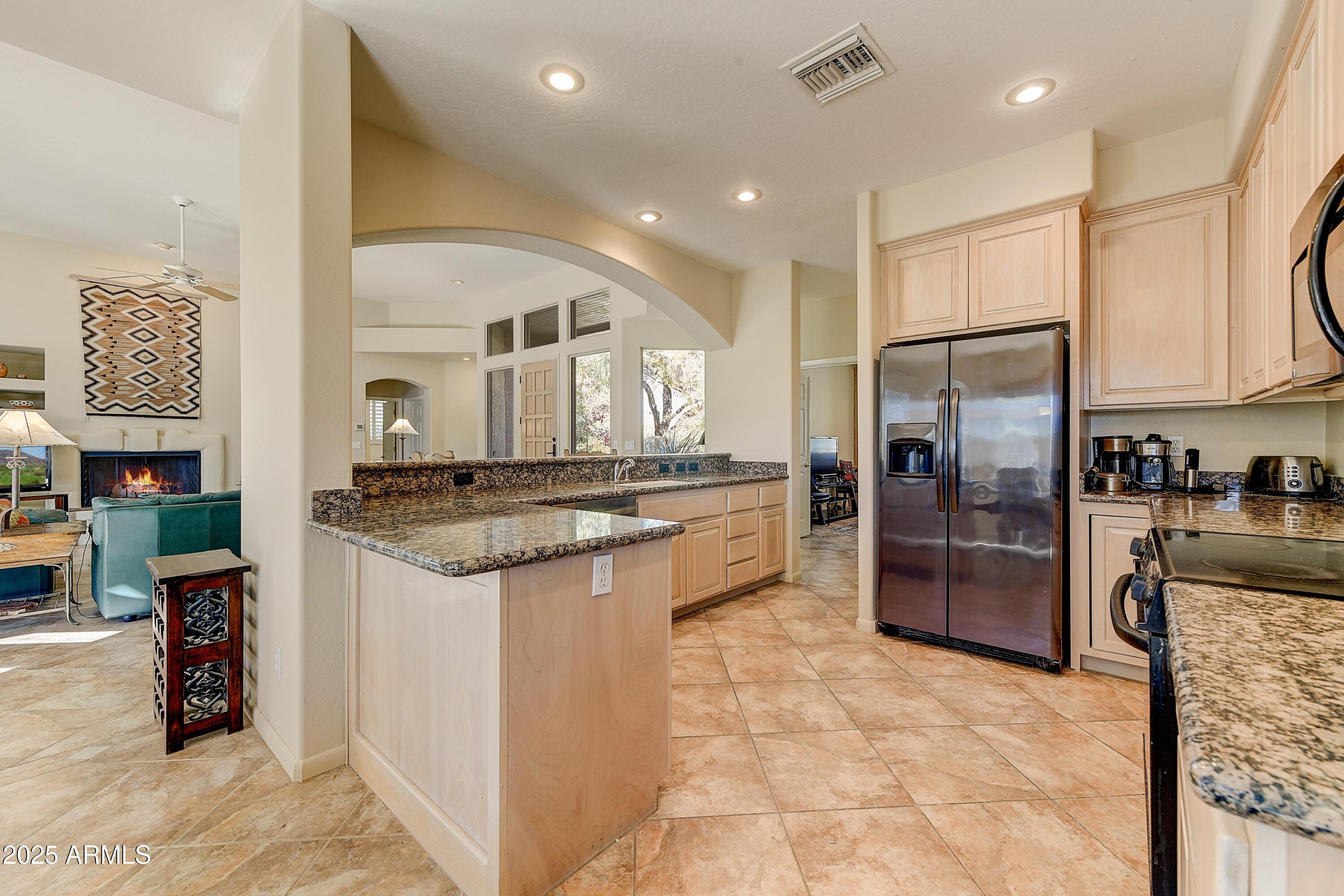 27502 North Azatlan Drive Rio Verde, AZ 85263 - Photo 12 of 21 a kitchen with stainless steel appliances granite countertop a refrigerator and a sink