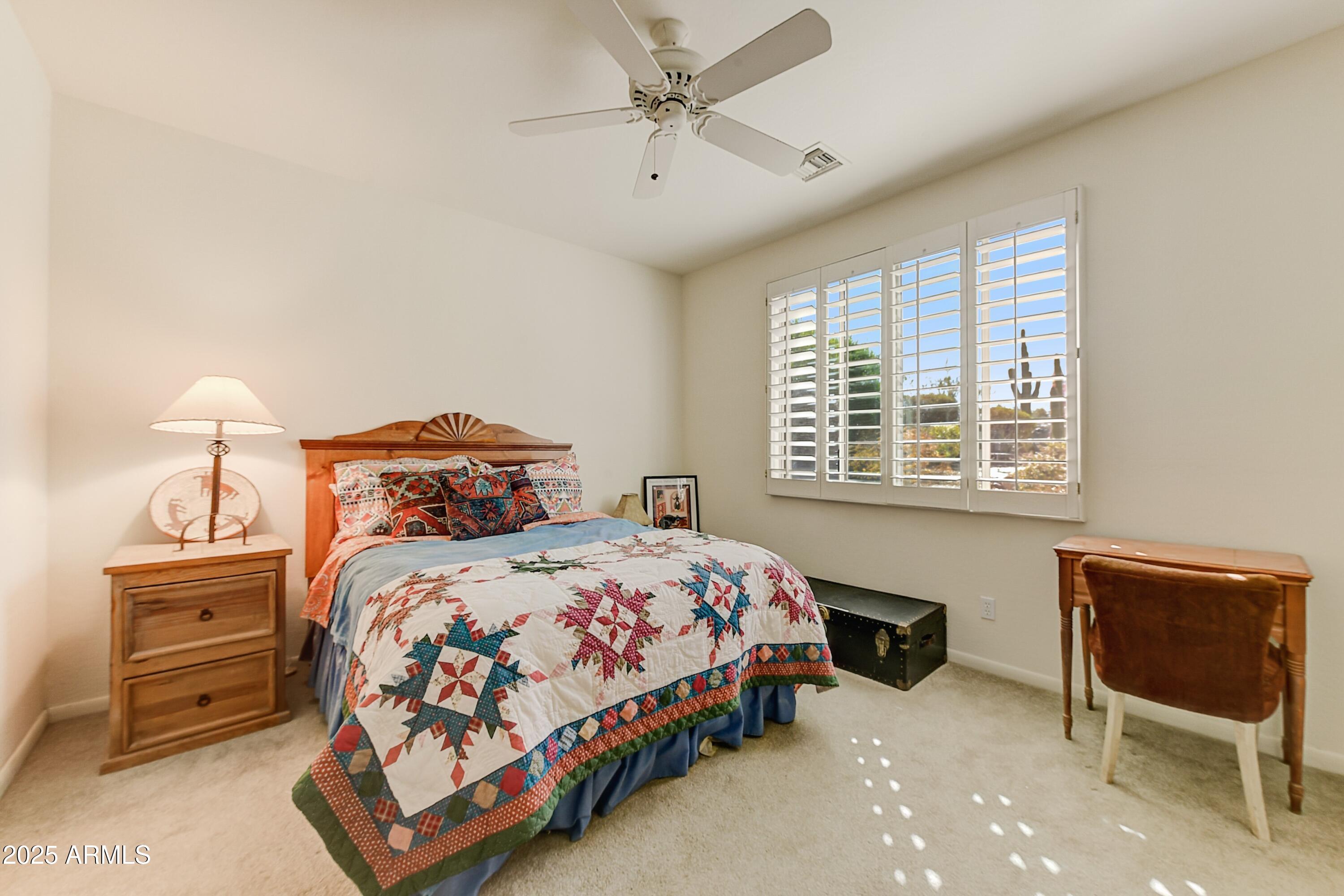 27502 North Azatlan Drive Rio Verde, AZ 85263 - Photo 14 of 21 a bedroom with a bed a dresser and a window