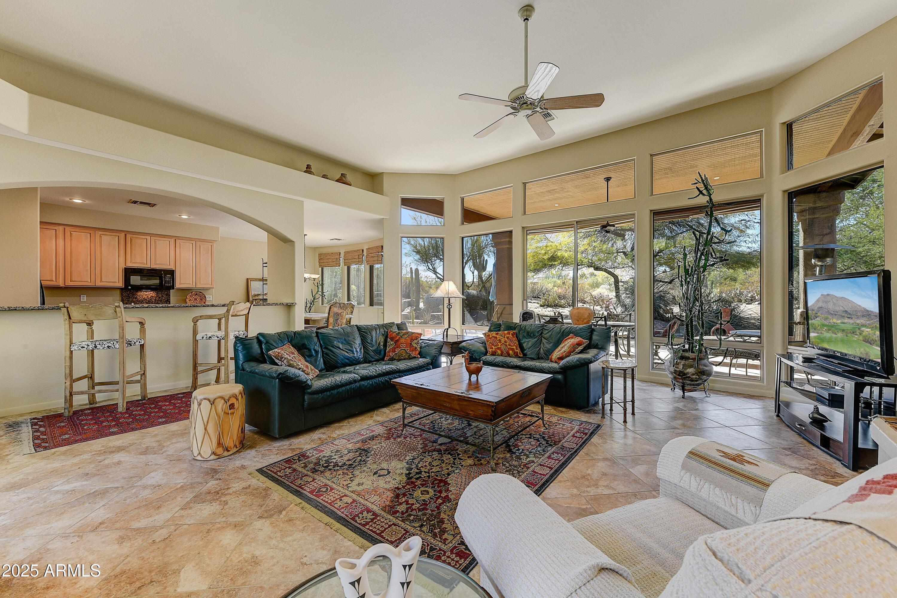 27502 North Azatlan Drive Rio Verde, AZ 85263 - Photo 4 of 21 a living room with furniture and a flat screen tv
