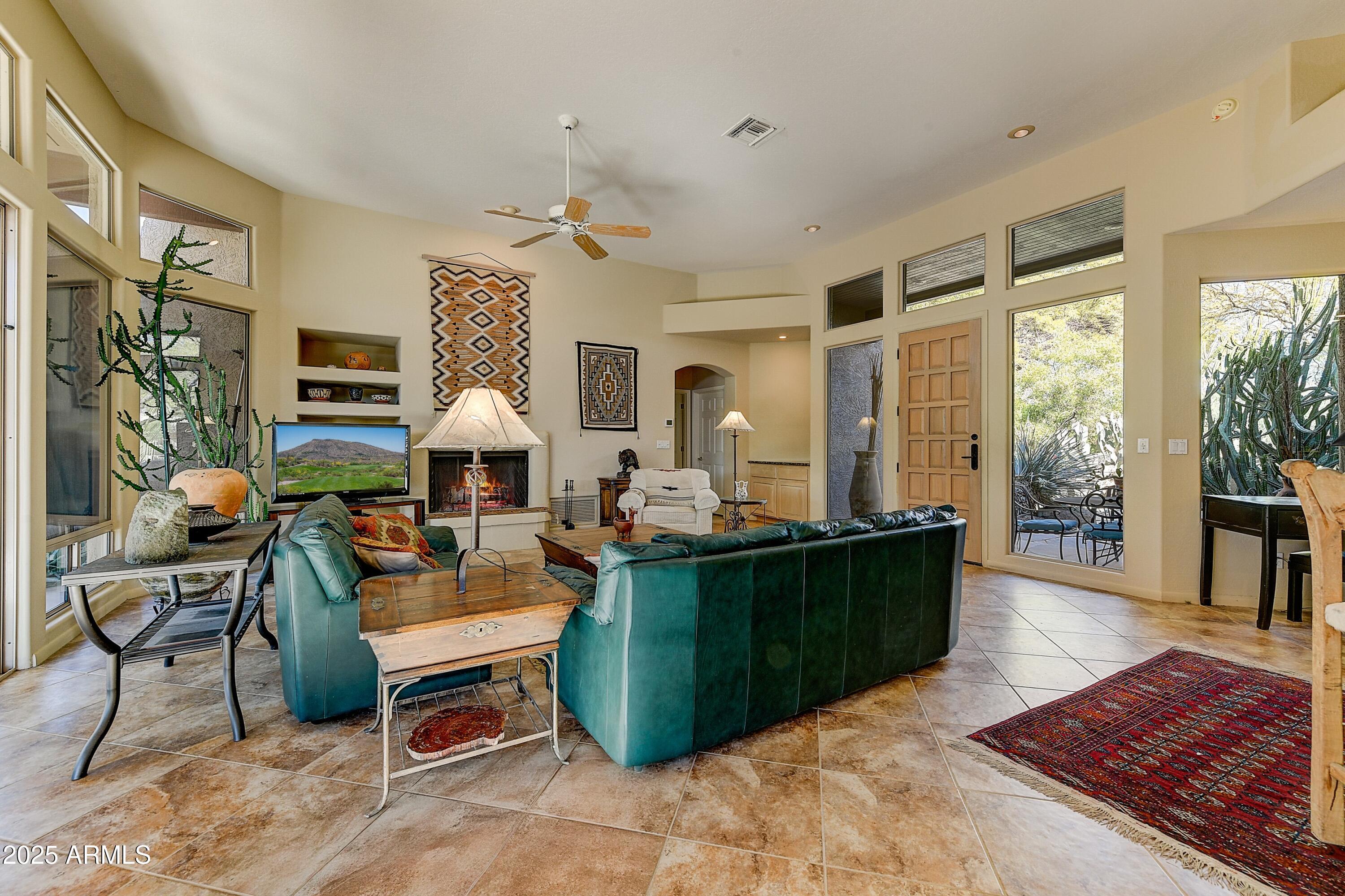 27502 North Azatlan Drive Rio Verde, AZ 85263 - Photo 5 of 21 a living room with furniture and a fireplace