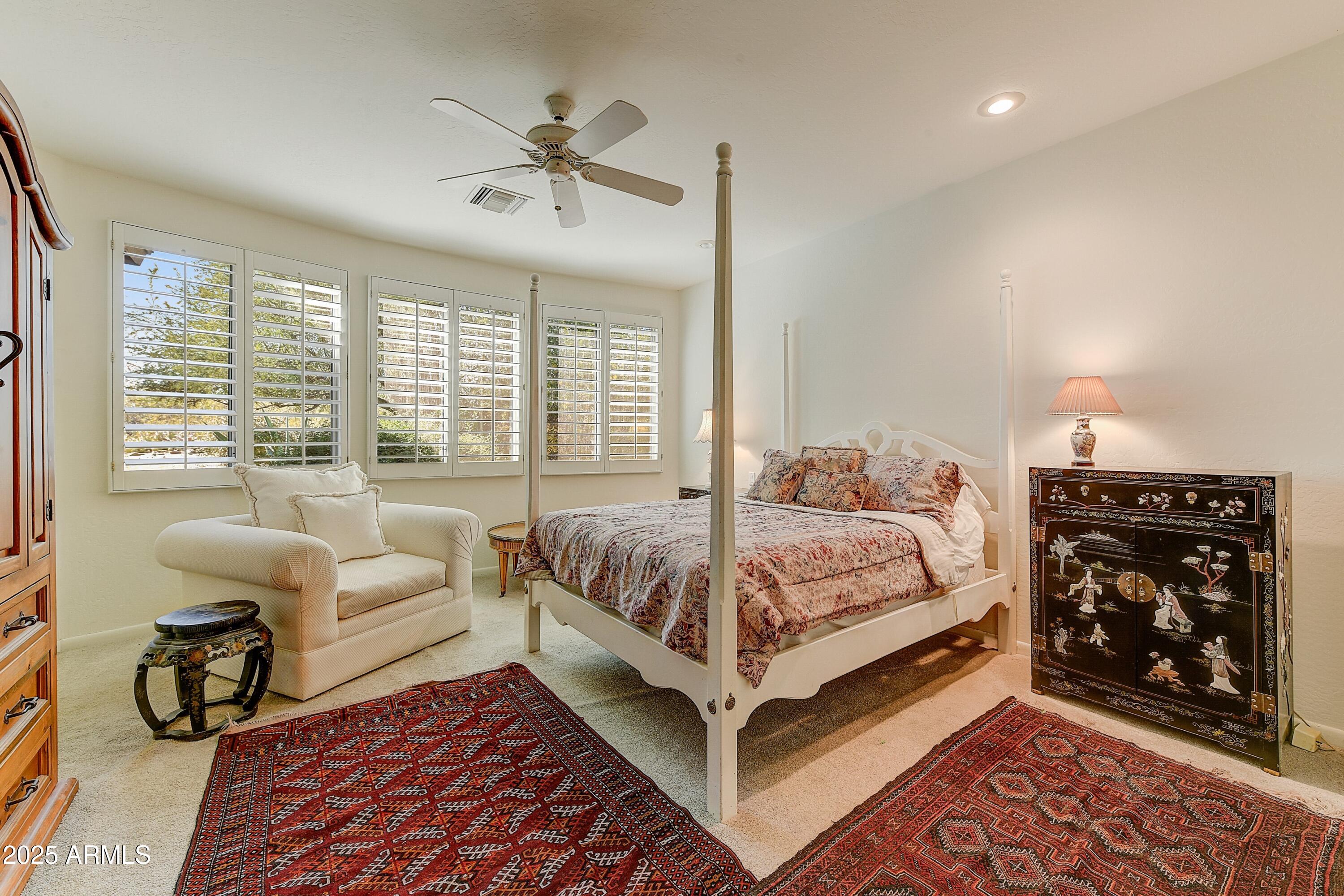27502 North Azatlan Drive Rio Verde, AZ 85263 - Photo 7 of 21 a bedroom with a bed a couch and a window