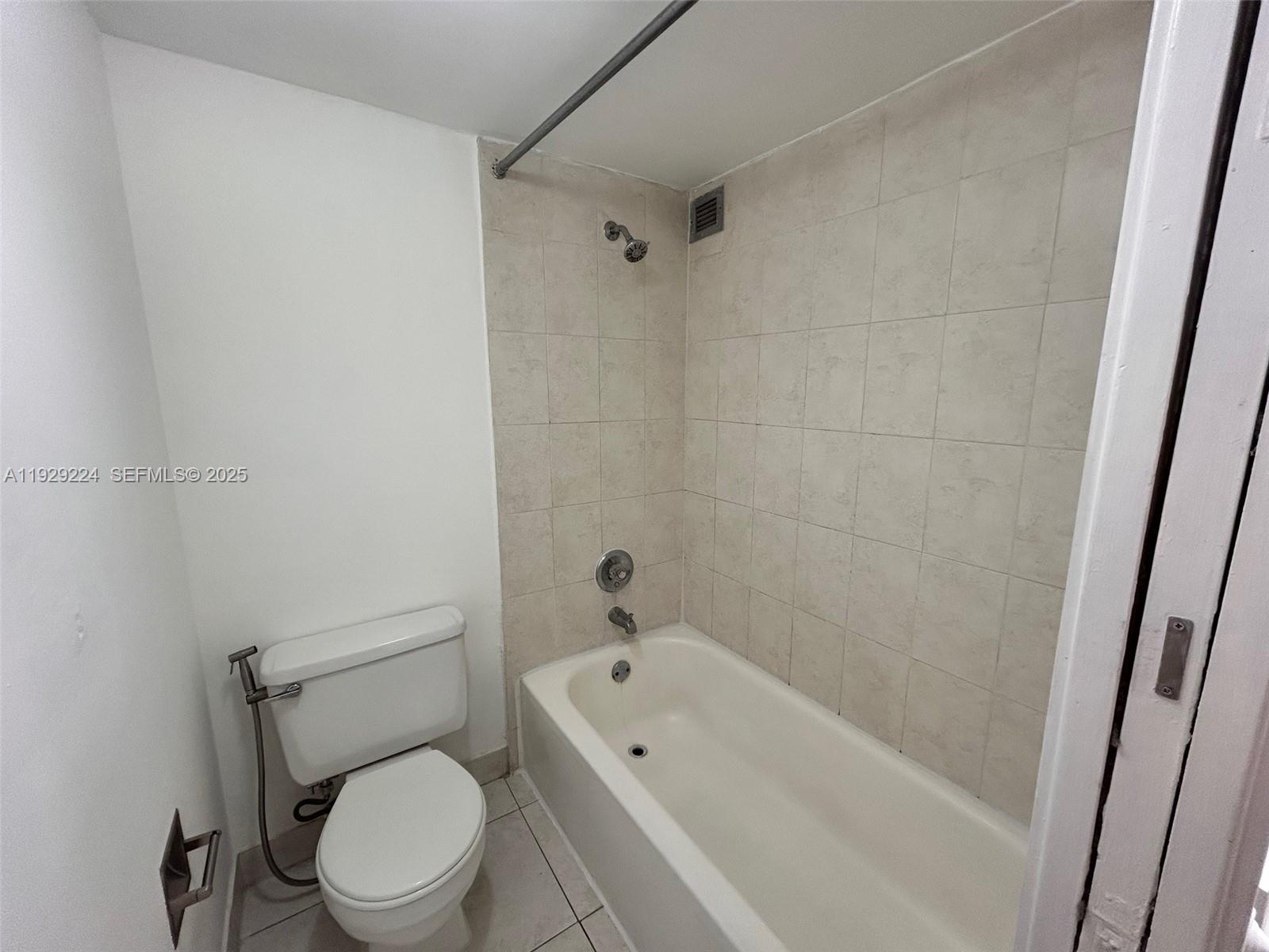 16919 North Bay Road, Unit 214 Sunny Isles Beach, FL 33160 - Photo 25 of 42 a white toilet sitting next to a bathtub